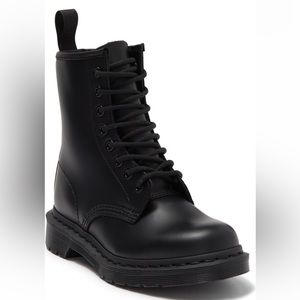Doc Martens combat boot featuring a lace-up vamp and lugged sole.